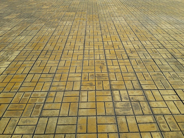 The pattern of tiles on the floor yellow cobblestone road