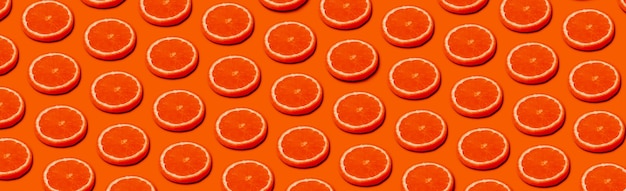 Pattern with orange citrus fruits on a orange background, panoramic  image in pop art style