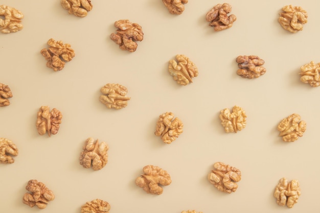 Pattern with peeled halves of walnuts top view Food abstract background with nuts