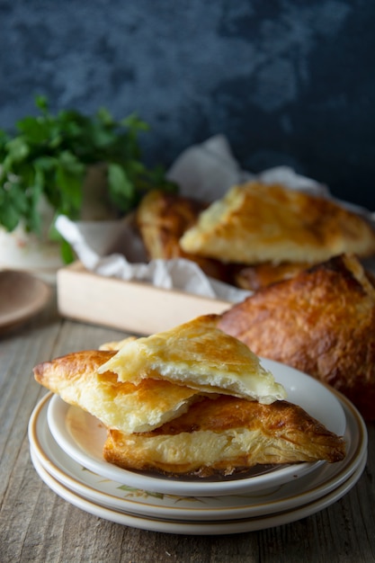 Patties with cottage cheese. Russian pastry, rustic wooden background. Traditional breakfast.