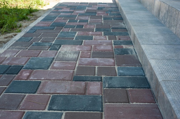 Paving slabs of different colors and shapesTexture of different colored patterned paving slabs Modern road surface