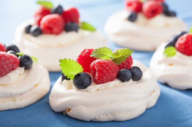 Pavlova meringue cake with cream and berry