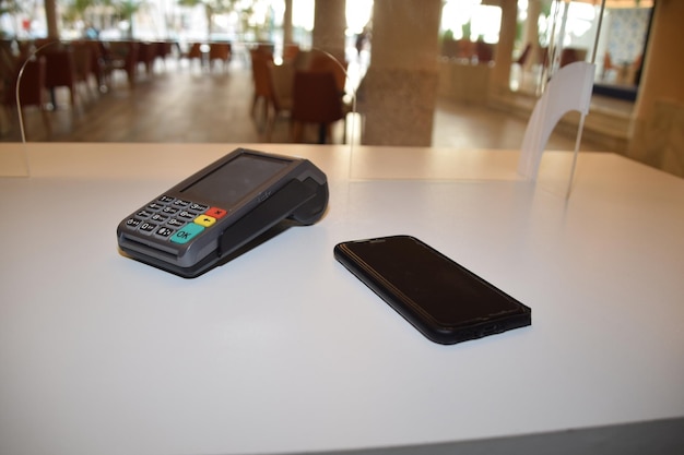 A payment terminal near a smartphone electronic payment concept