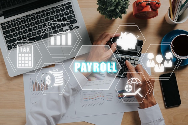 Payroll business finance concept Businessman analyzing financial data with Payroll icon on VR screen Financial accounting