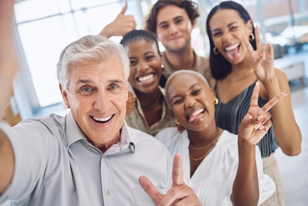 Peace hand selfie and office friends at fun and friendly company with playful business culture Team photo in a meeting with diverse goofy and silly staff with positive coworking relationship