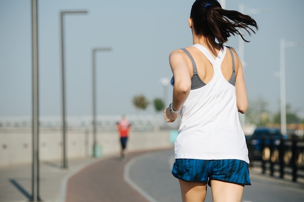 Peaceful athletic woman running on the new track outdoors