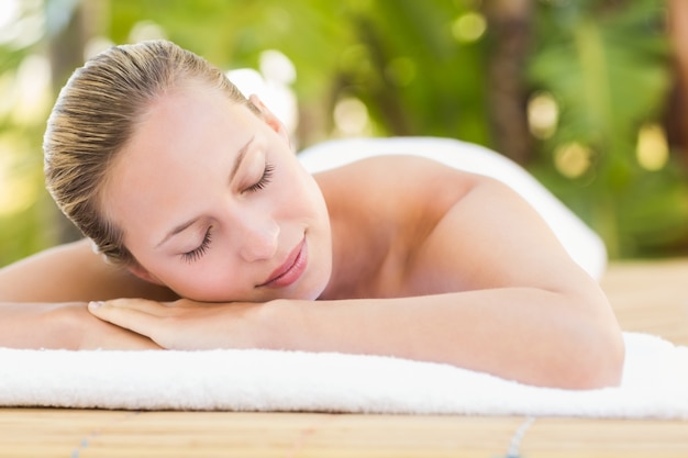 Peaceful blonde lying on towel 