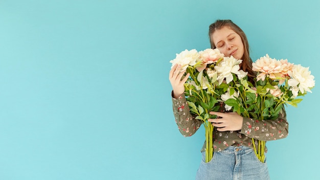 Peaceful woman holding flower bouquet