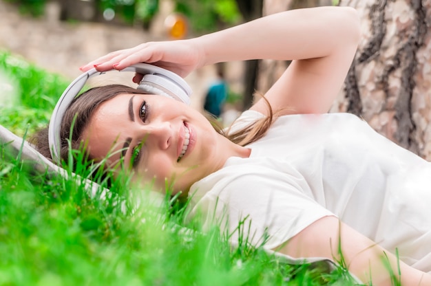 Peaceful woman listening to music with headphones outdoors