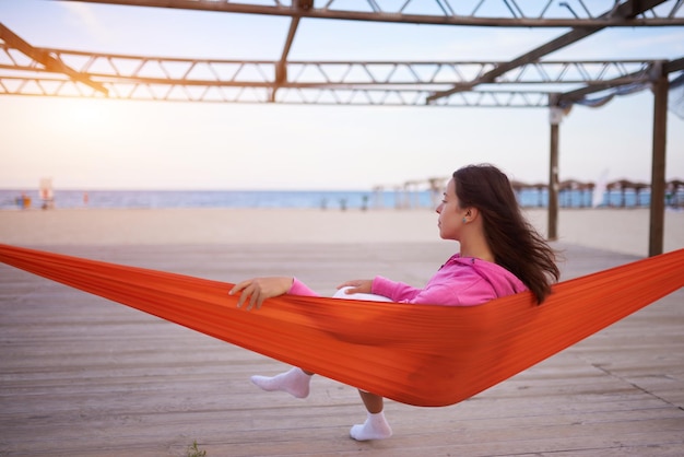 Peaceful woman relaxing on hammock on the beach