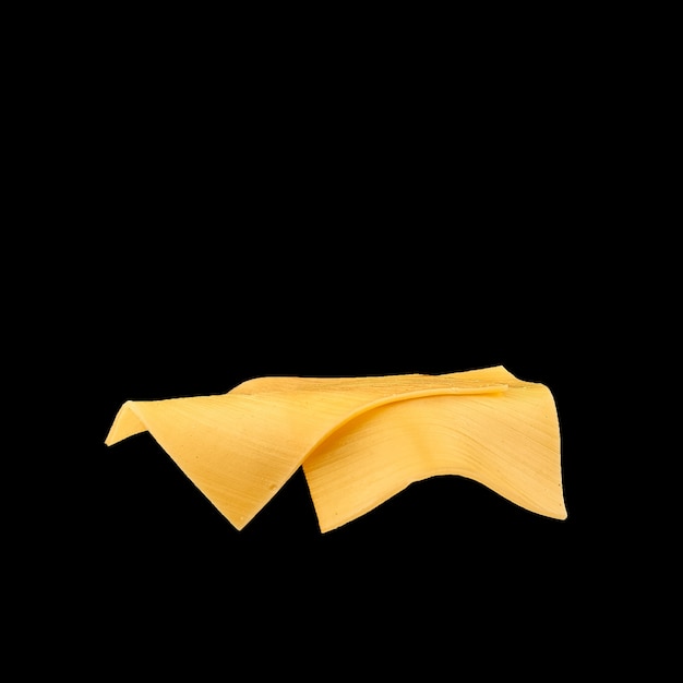 Peaces of yellow cheese flying on a black