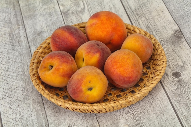 Peach heap in the wooden basket