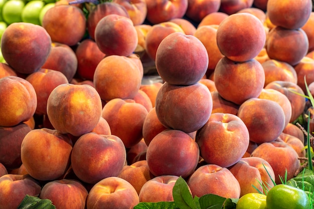 Peach on the market counter Pile of ripe peaches