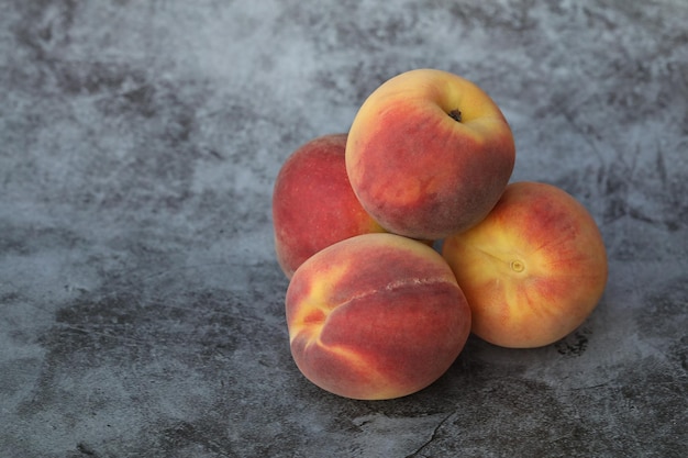 peaches on the grey background with copy space