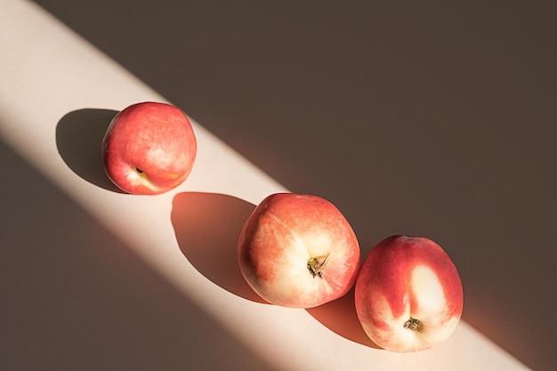 Peaches in sunlight Minimalism trendy still life with shadow