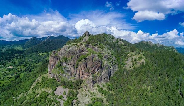 Peak of rhodope mountain with forests against background of clouds panorama top view