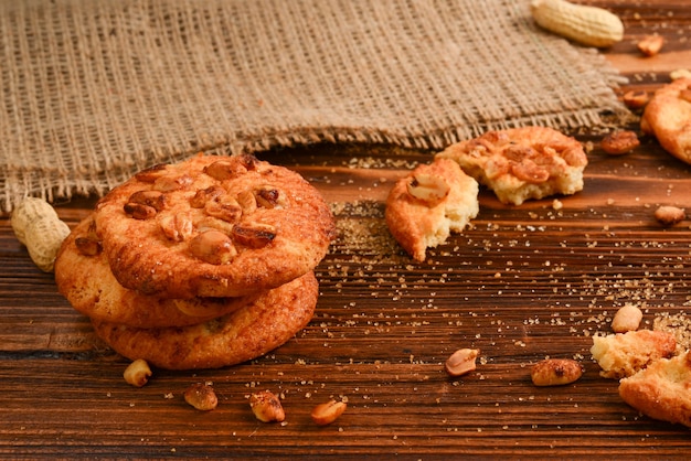 Peanut cookies on wooden table with sugar.