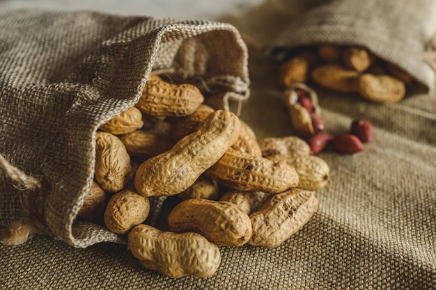 Peanuts in a bag on a woody background