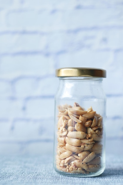 Peanuts in a glass jar on table