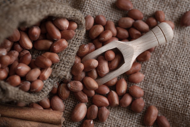 Peanuts seed in sackcloth bag on wooden table