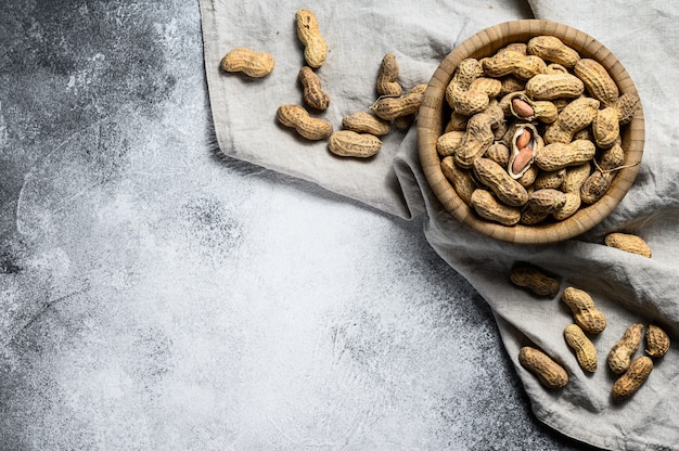 Peanuts in a shell, Organic raw groundnut, top view, Space for text.