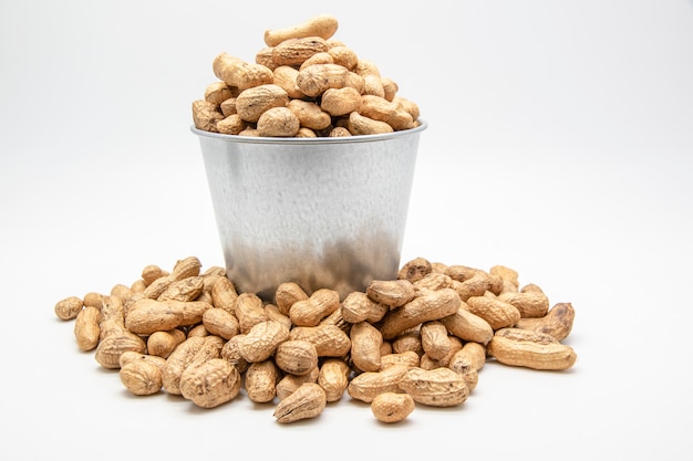 Peanuts in a tin bucket on white 