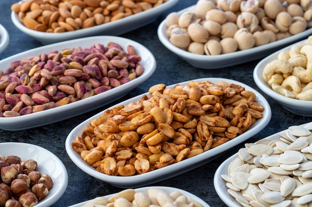 Peanuts with hot sauce in selective focus Types of nuts found in bulk on a dark background