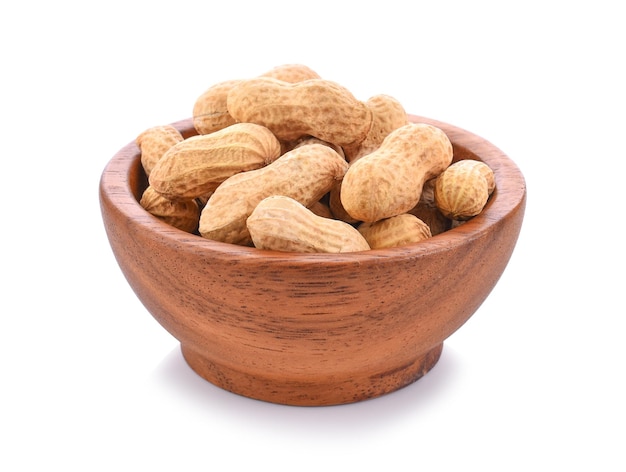 Peanuts in wooden bowl on white background