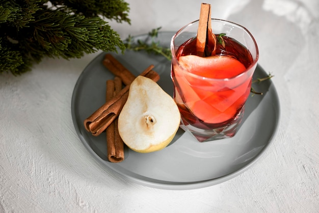 Pear cocktail with rum liquor pear slices and rosemary on white table selective focus