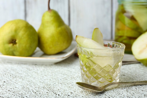 Pear juice with fresh fruits on table close up