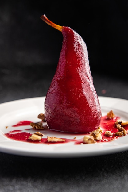 pear in red wine sweet dessert french cuisine healthy meal food snack on the table copy space food