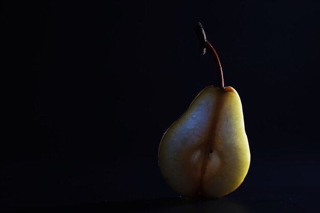 Pear slices on a black background.pears in a plate and slices of pears top view.