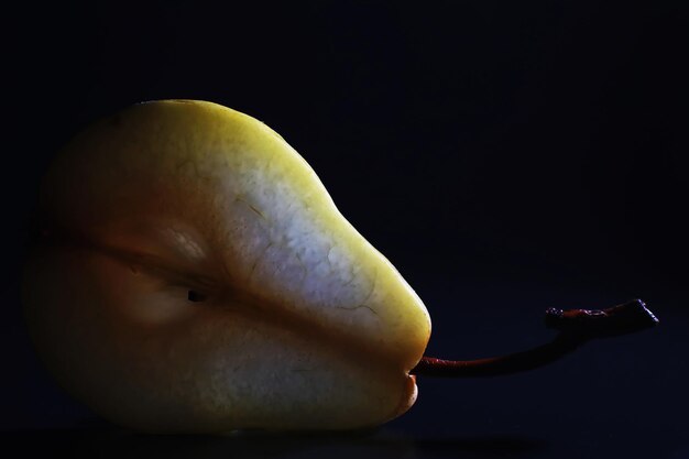 Pear slices on a black background.pears in a plate and slices of pears top view.