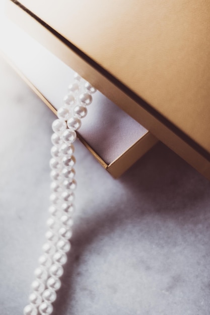 Pearl jewellery in a golden gift box