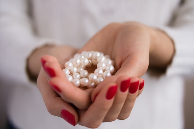 Pearls in female hands