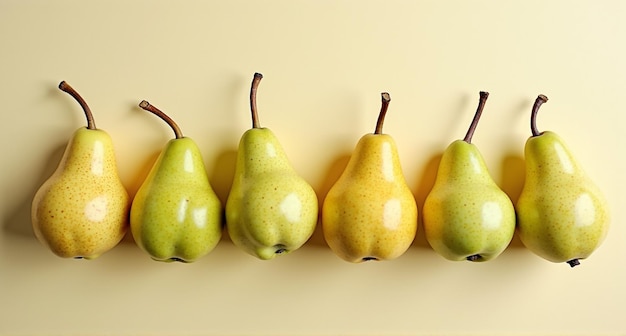 Photo pears hanging on a wall one of which has a yellow pear on it