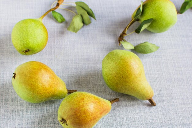 Pears in a plate and slices of pears top view wooden background with pears