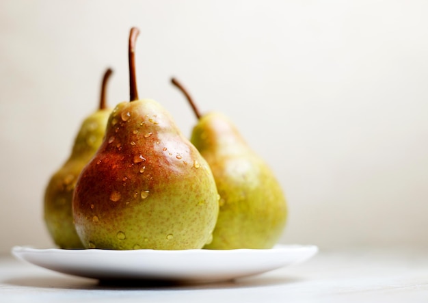 Photo pears on a plate on the table