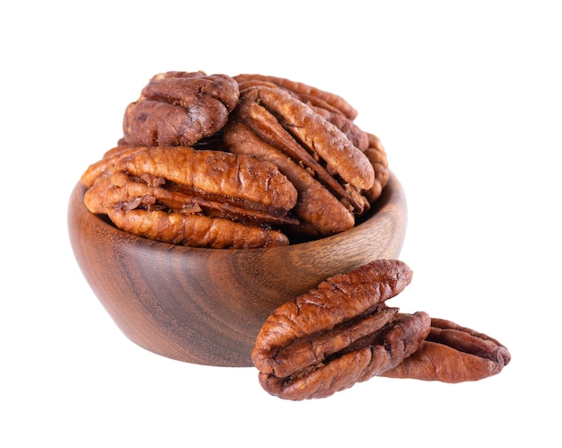 Pecan nuts in wooden bowl isolated on white background Shelled pecan Clipping path