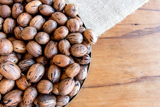 Pecan nuts on wooden table. Top view.