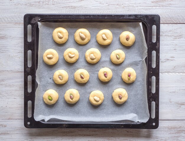 Peda (Indian sweet) cookies on a baking sheet. Eid and Ramadan Dates Sweets - Arabian cuisine.