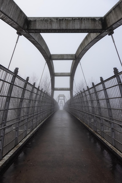 Pedestrian bridge over the TransCanada Highway 1 during a winter foggy morning