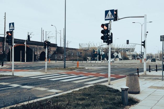 Pedestrian crossing which is controlled by a traffic light Red bike carpet with white stripes