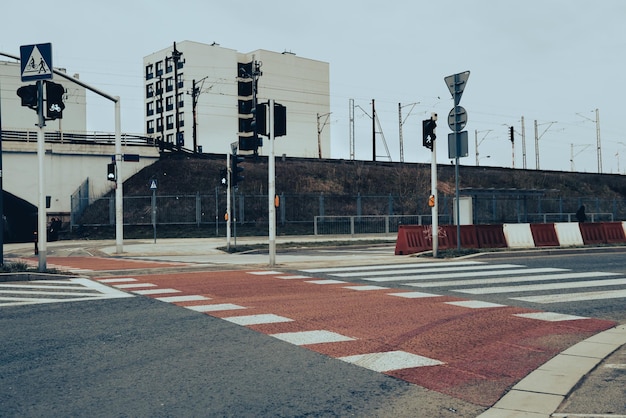 Pedestrian crossing which is controlled by a traffic light Red carpet with white stripes