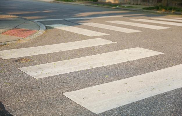 A pedestrian crossing with white stripes on the road