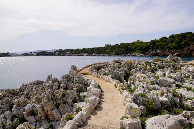 Pedestrian path by mediterranean sea on the tourist coast JuanlesPins in Antibes France