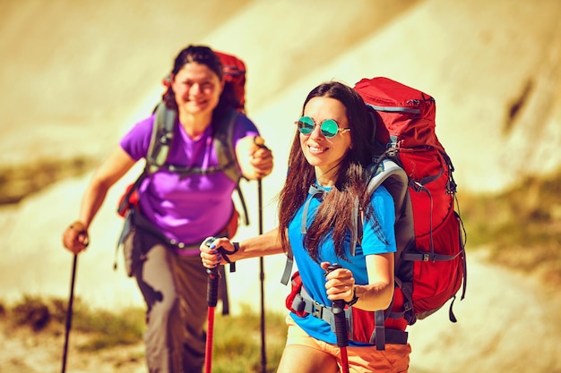 Pedestrian tourism, people travel with backpacks, in the open air.