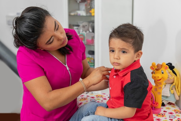 Pediatric doctor checking a child who feels bad in her office