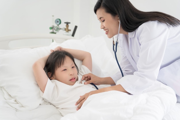 Pediatric doctor exams little girl with stethoscope