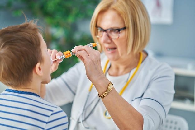 Pediatrician doctor examining little kids in clinic. High quality photo